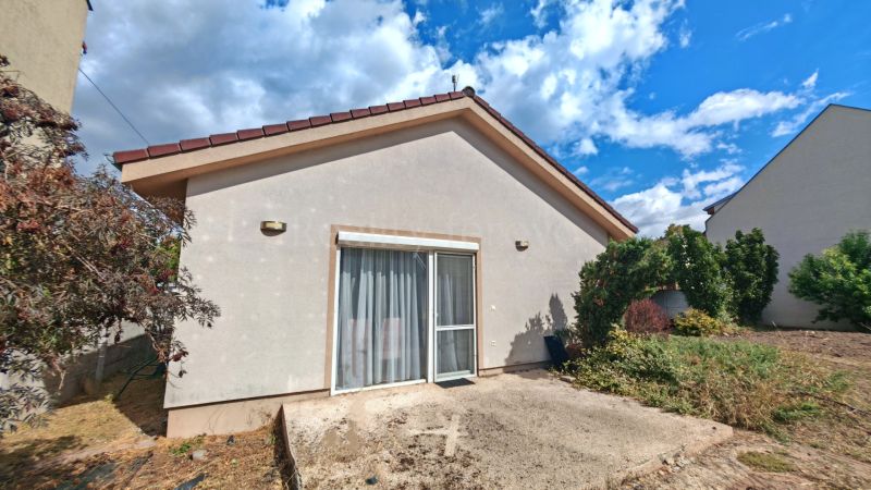 A family house in Matúškovo with a terrace and a garden with lush greenery.