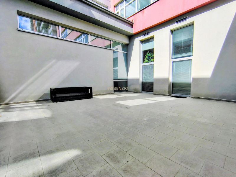 Outdoor terrace of offices on Bajkalská in Bratislava - Ružinov with paving and a bench.