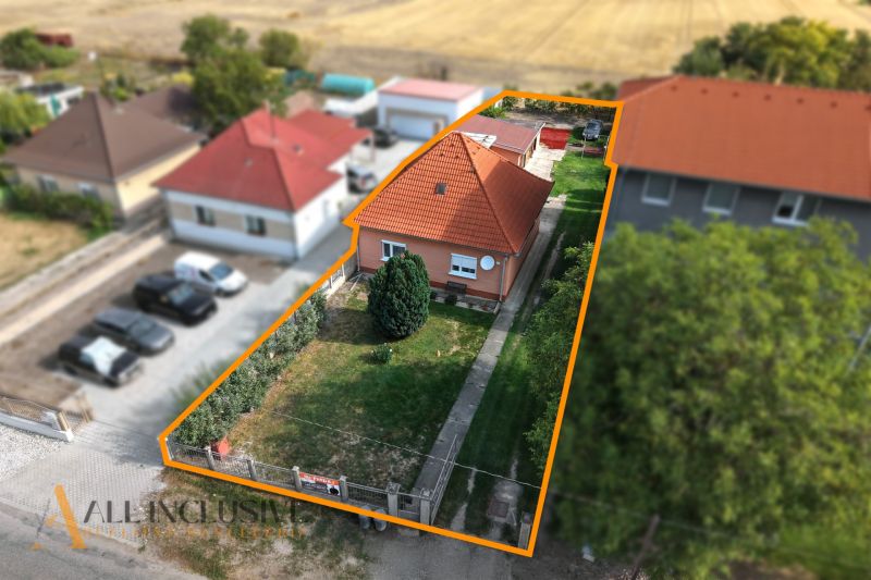 A family house in Povoda with a red roof and a landscaped garden surrounded by greenery.