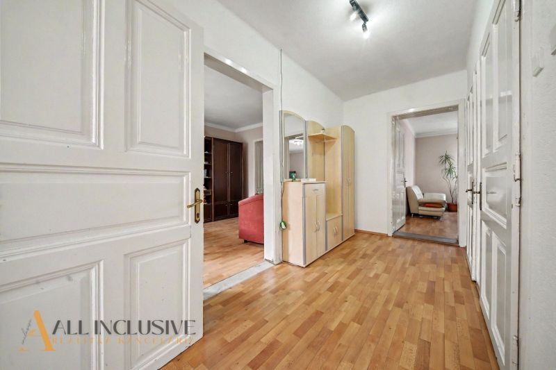 In the interior of the family house, there is a hallway with a wooden decor floor and a wardrobe.