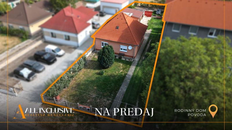 A family house in Povoda surrounded by a garden and a paved driveway.