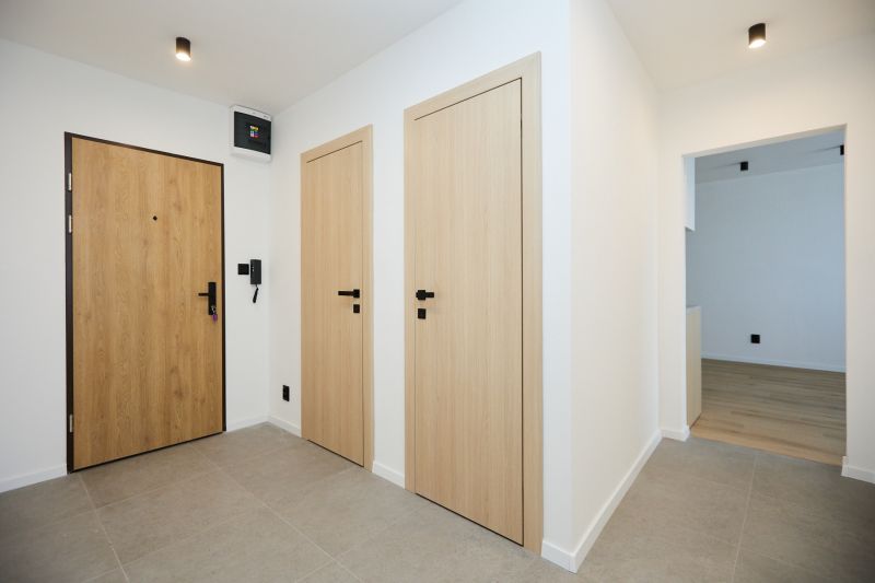 Entrance hallway in a 2-room apartment with wooden doors and tiles.