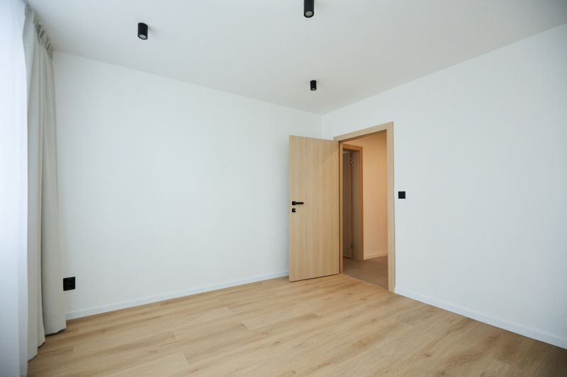 A bright room with wood-decor flooring in a two-room apartment.