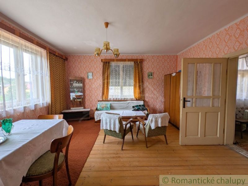 Living room in a family house with a wooden decor floor and retro furniture.