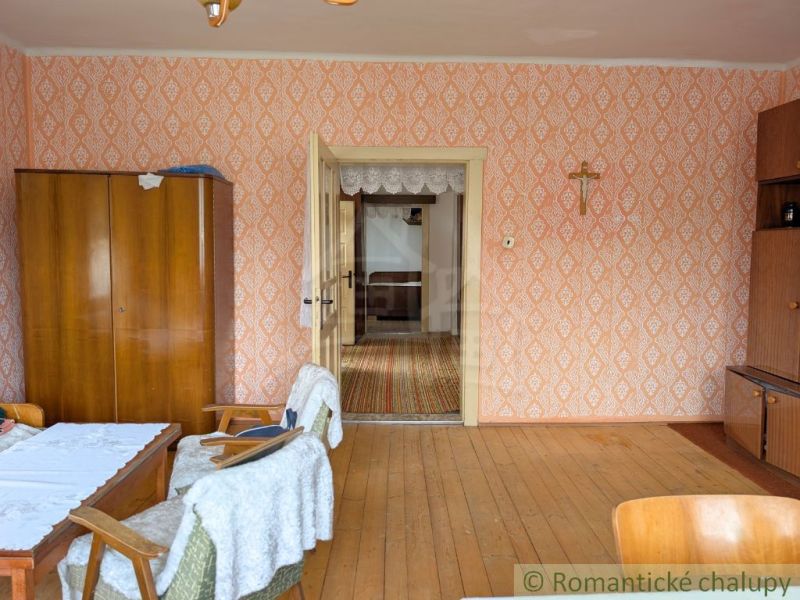 Interior of a family house with a wooden decor floor and vintage wallpapers.