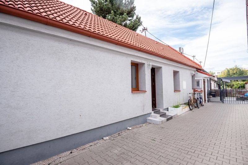 A family house on Roľnícka Street in Bratislava - Vajnory with a red roof and bicycles.