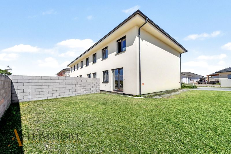 A family house in Dolný Bar with two floors and a green lawn.