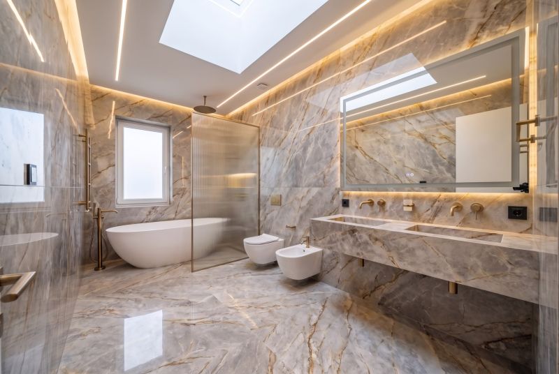 Luxury bathroom with marble tiles, bathtub, and wall-hung toilet in a family house.