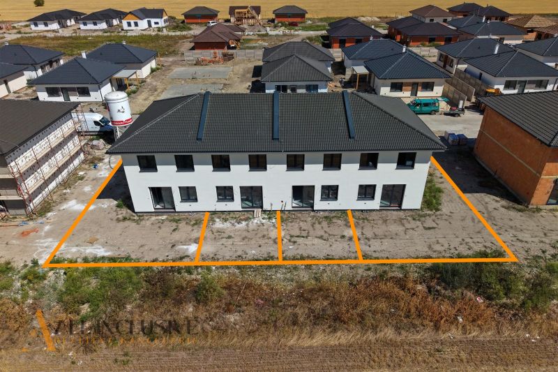 A family house in Dolný Bar near other properties on an extensive construction site.