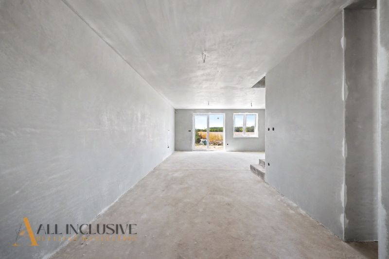 A view of a spacious interior in a family house with a concrete floor.