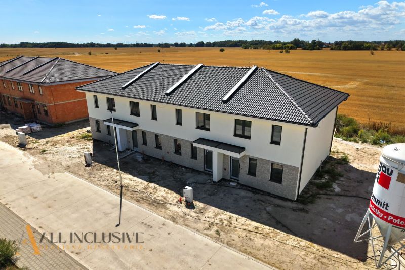 A family house in Dolný Bar with a sloped roof, located in the countryside.