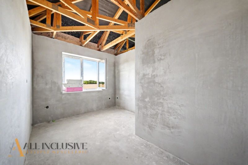 Gray walls and wooden beams in the interior of a family house.