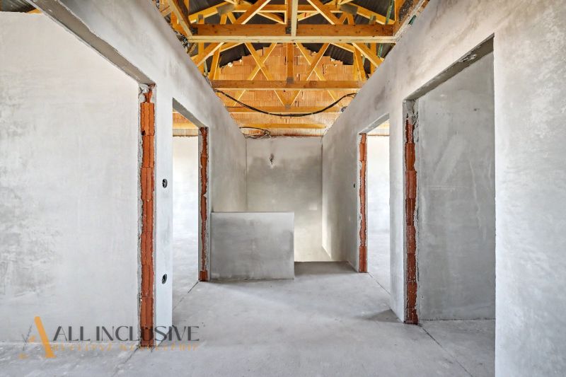 An interior with open spaces and wooden beams in a family house.
