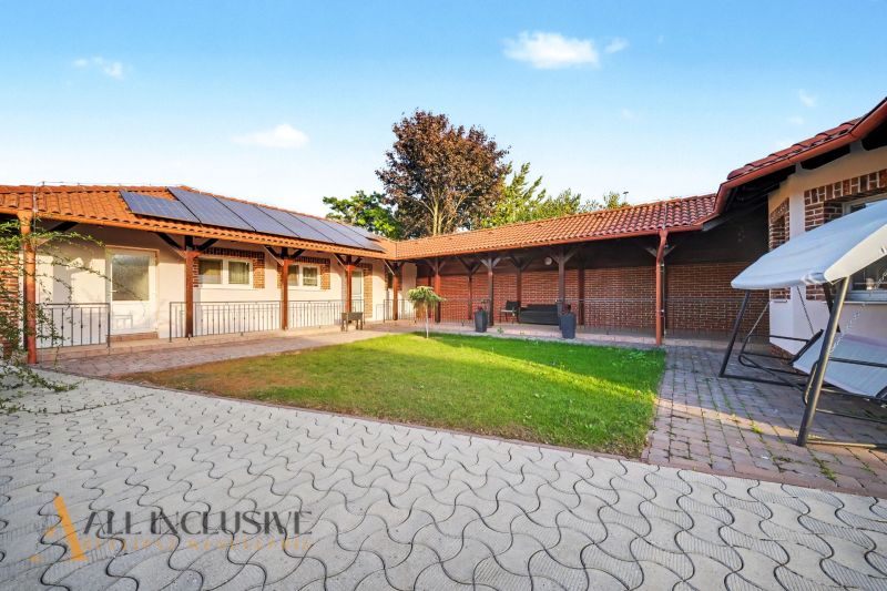 Family house in Kostolné Kračany, Dunajská Streda with a paved courtyard and solar panels.