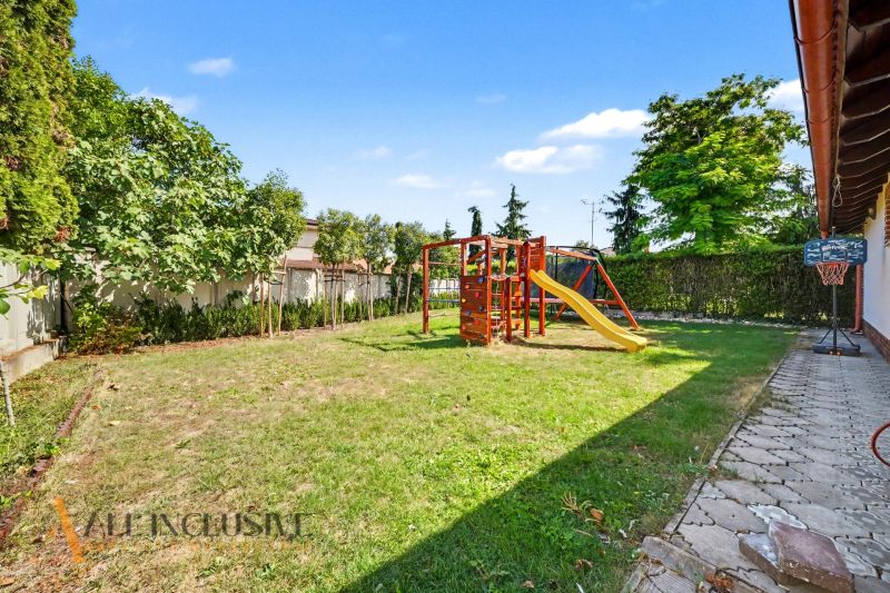 The garden of a family house in Kostolné Kračany with a playground and a basketball hoop.
