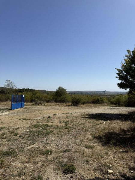 Agricultural and forest lands in Pezinok, Kučišdorfská Street, with a blue entrance gate.