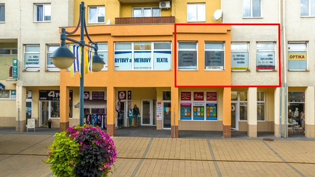Commercial premises on Moyzesova Street in Púchov with shops and floral decorations.