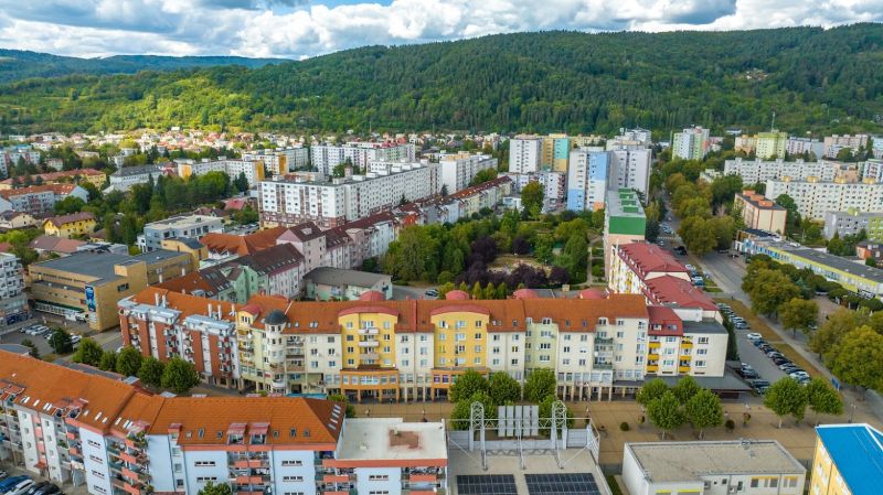 Moyzesova Street in Púchov with apartment buildings and greenery, Commercial spaces.