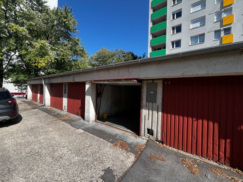 Row of garages on Hanulova Street in Dúbravka, Bratislava next to the apartment building.