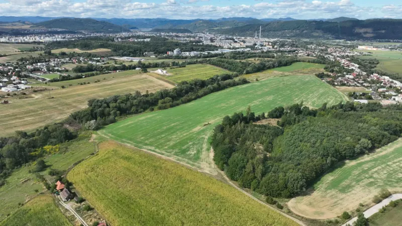 Agricultural and forest land in Žilina with a panoramic view of the surrounding mountains and the city.