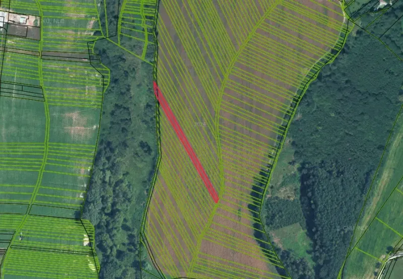 Aerial view of agricultural and forest lands in Žilina with marked parcels.
