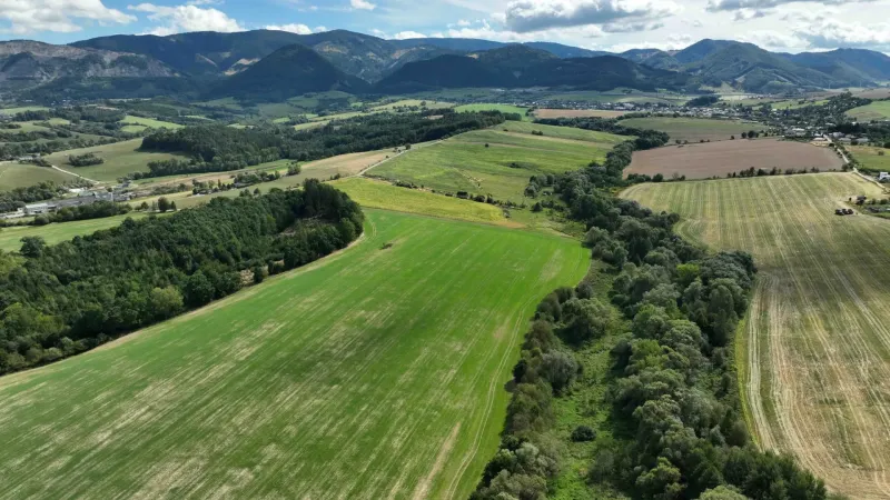 Aerial view of agricultural and forest lands around Žilina with a mountainous scenery.