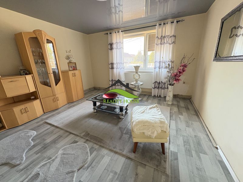 Living room of a family house with furniture and a wooden decor floor.