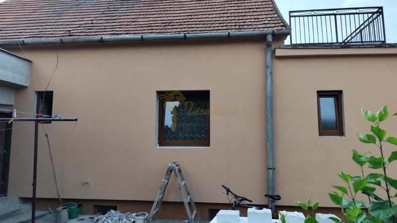 A family house in Krušovce with a brick roof, windows, and exterior decorations.