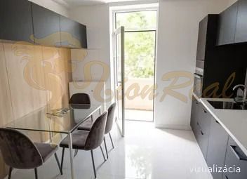 Kitchen in a 2-room apartment with a dining table and access to the balcony.