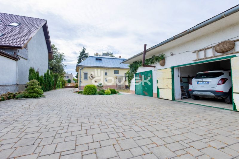 A family house on Topolianska Street in Michalovce with a garage and a paved courtyard.