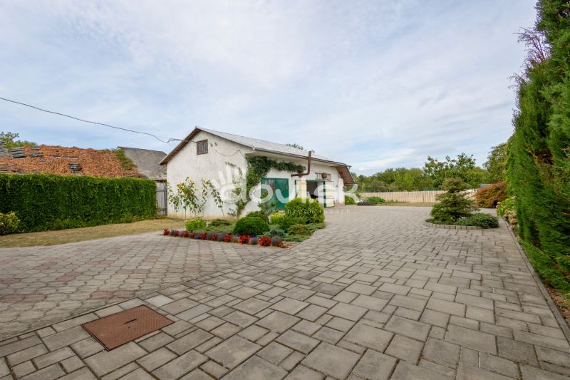 A family house on Topolianska Street in Michalovce with a paved yard and a neat hedge.