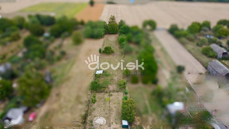 A plot in Michalovce, on Topolianska Street, with a grassy area and trees.