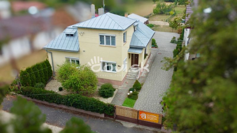 Family house on Topolianska Street in Michalovce, garden and paved walkway.