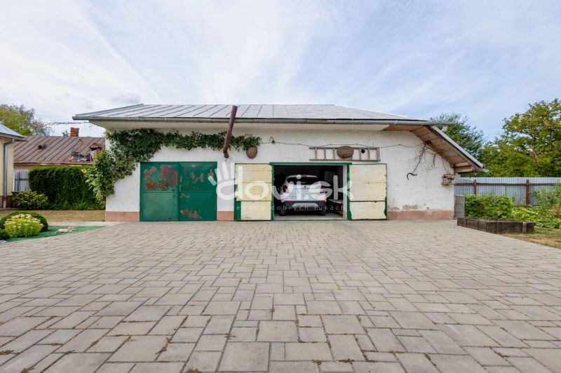 A garage at a family house on Topolianska Street in Michalovce with a car inside.