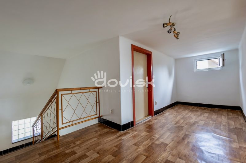 Interior of a family house with a wooden decor floor and a staircase.