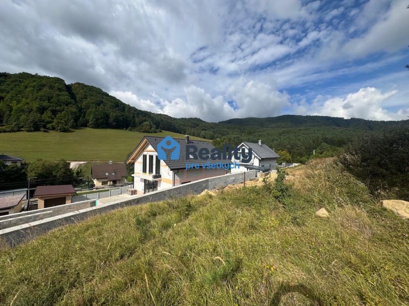 A house in a natural setting with hills in Považská Bystrica, a suitable location for living.