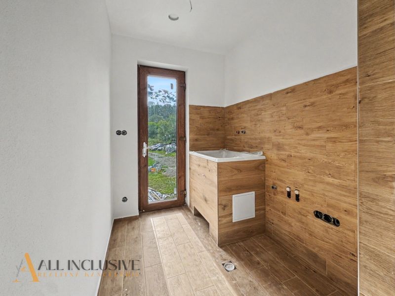 Interior of a family house with wooden decor and a view of the garden.