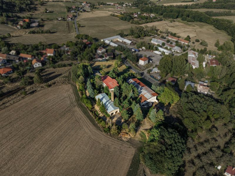 Development plots in Slatinské Lazy surrounded by fields and greenery.