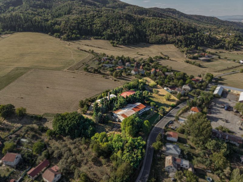 Aerial view of development plots in Slatinské Lazy surrounded by forests and meadows.