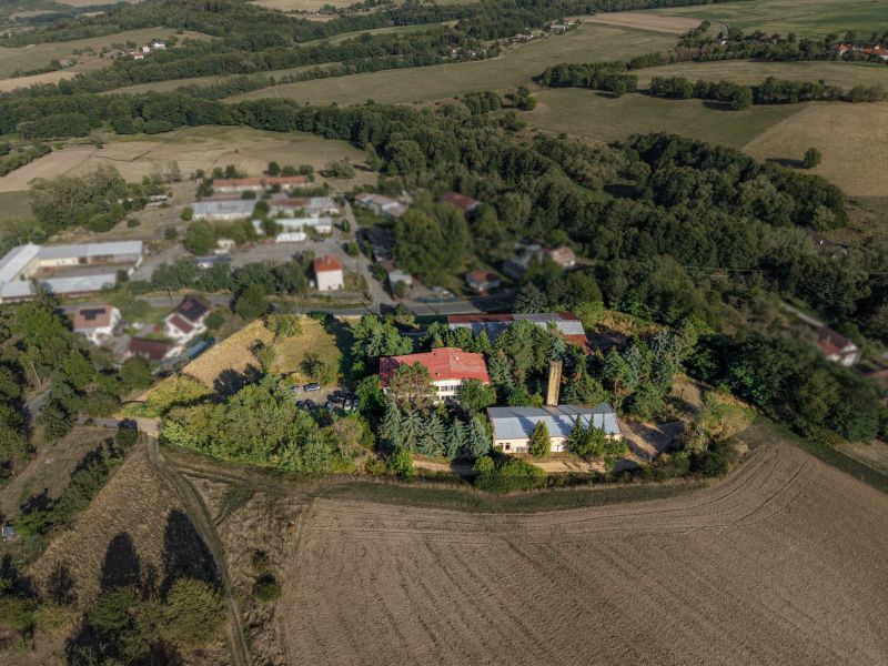 Aerial view of development plots in Slatinské Lazy surrounded by nature and buildings.