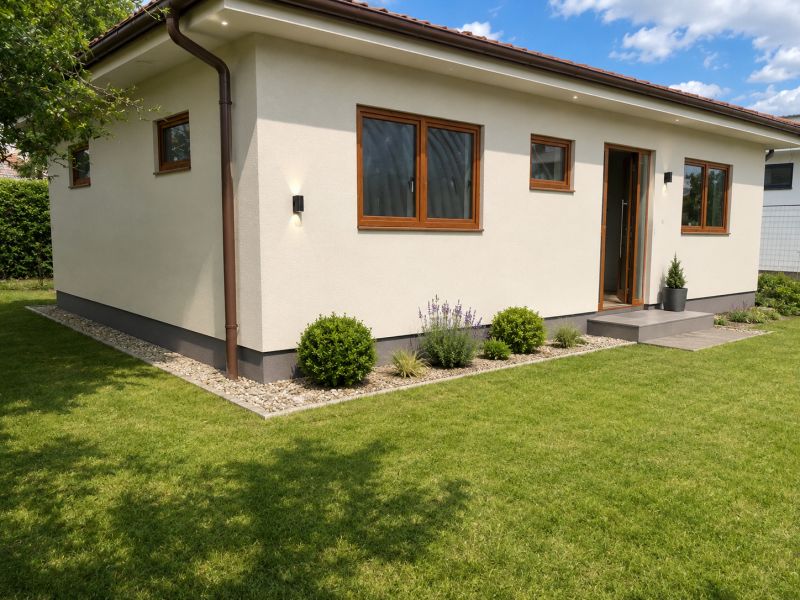 A family house in Šamorín with a well-maintained lawn and simple garden planting.