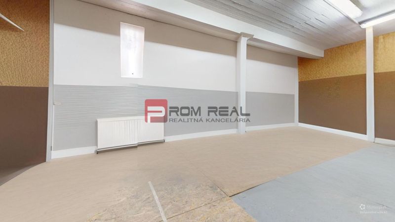An empty office space with wood-patterned flooring and white walls.