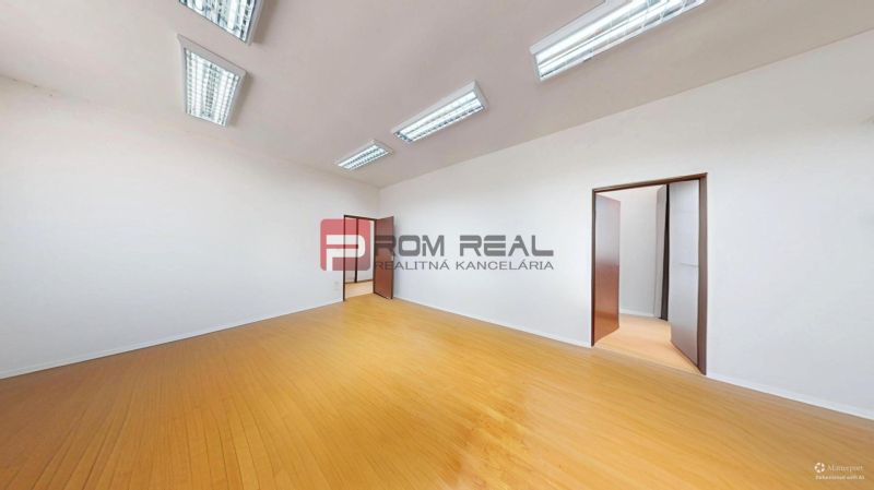 Offices with white walls and a wooden decor floor, bright lighting.