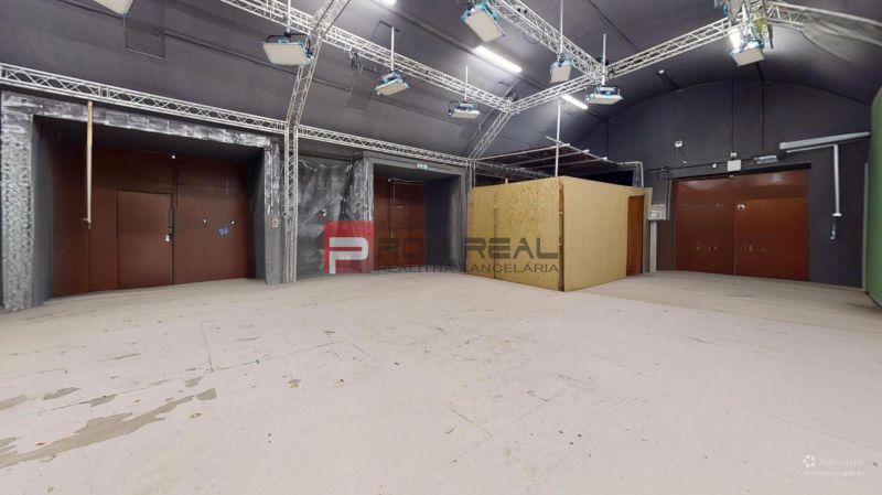 A large office space with lighting equipment and a wooden decor floor.