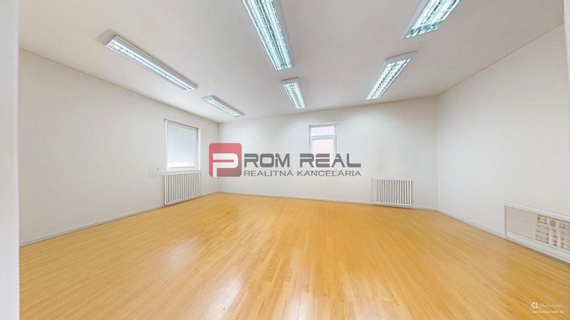 Offices with white walls and wood-patterned flooring.