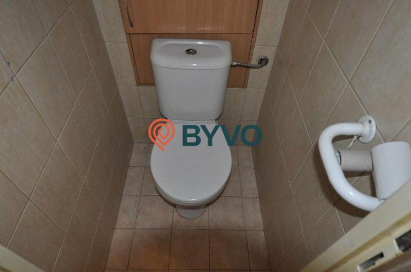 Bathroom in a 3-room apartment with tiles and a toilet, arranged in a practical space.