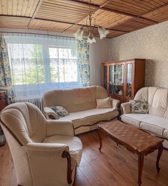 Living room in a family house with a wooden decor floor and comfortable furniture.