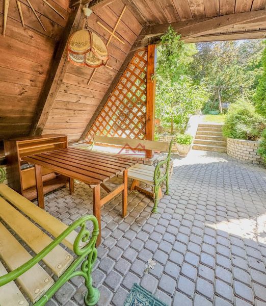 Terrace with a garden view, wooden benches in a family house in Sady nad Torysou.