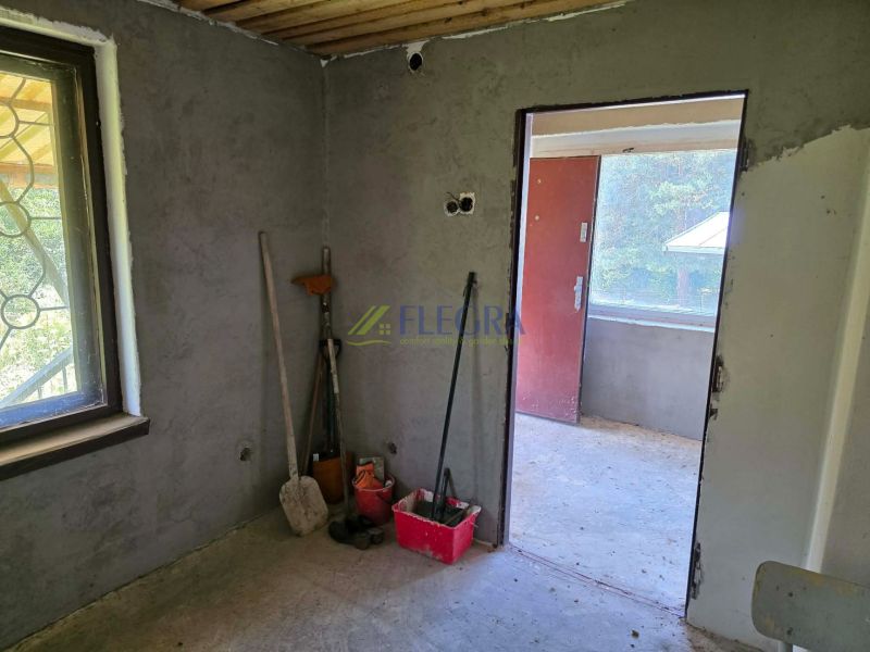 The interior of a cabin with unfinished walls and work tools.