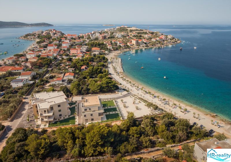 Aerial view of Sevid and a holiday apartment by the coast with a beautiful beach.
